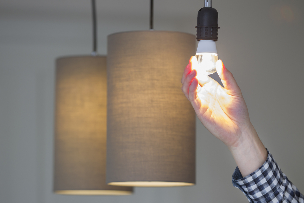 A,Man,Turning,A,Lighted,Lightbulb,In,His,Own,New